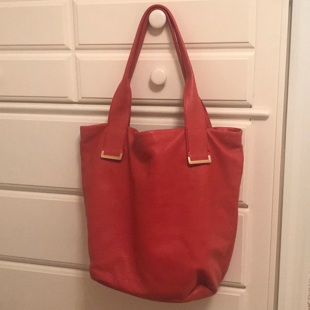 Orange/red leather bag, 17 1/2” wide x 14” tall.